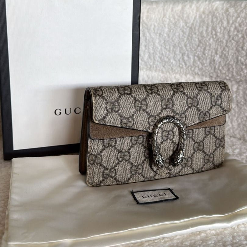 Gucci handbag with distinctive logo on a white surface